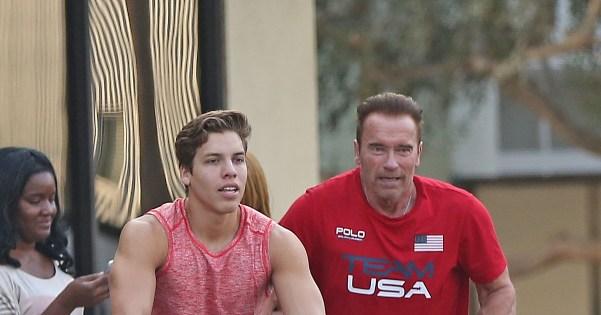 EXCLUSIVE. Coleman-Rayner Los Angeles, CA, USA. August 25, 2016. Like father like son; Arnold Schwarzenegger and his look-alike son Joseph Baena showing off their guns as they are seen leaving Gold's gym in Venice. The 'Terminator' star and his son Joseph left the gym with German actor Ralph Moeller and a friend on their bikes. CREDIT LINE MUST READ: Coleman-Rayner. Tel US (001) 310-474-4343- office Tel US (001) 323-545-7584 - Mobile www.coleman-rayner.com